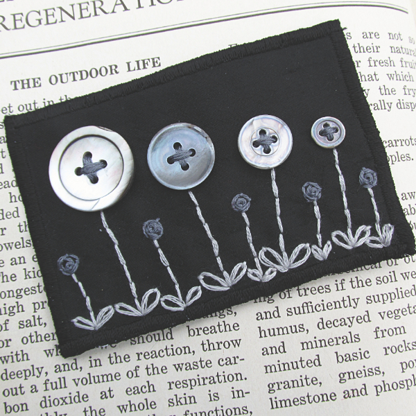 black silk ATC with flowers made of vintage buttons and embroidery