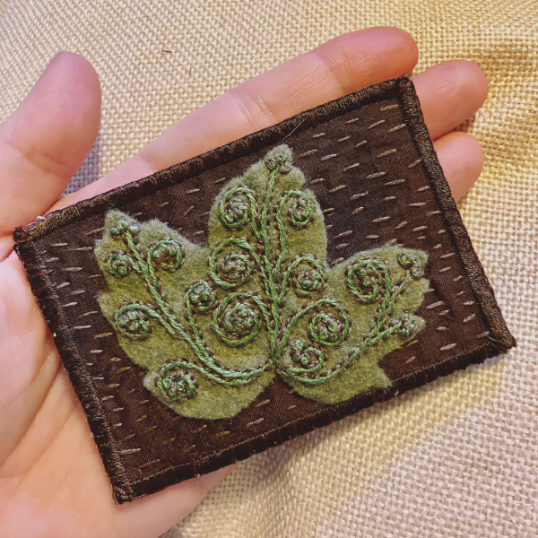 brown silk ATC with green embroidered leaf