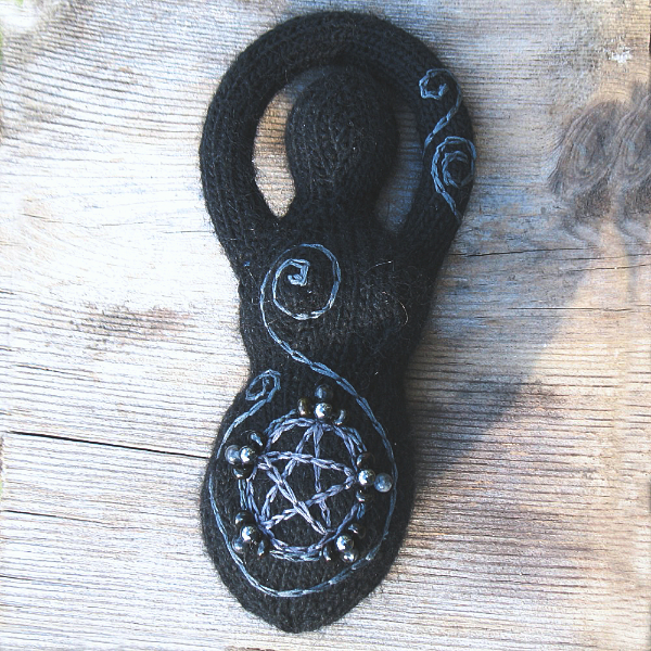 black knitted goddess with a gray embroidered pentacle and dark black beads