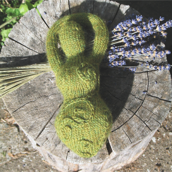 A green knitted goddess with embroidered spirals