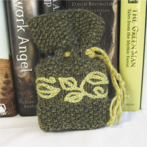 small olive green knitted pouch embroidered with pale green leaves and vines