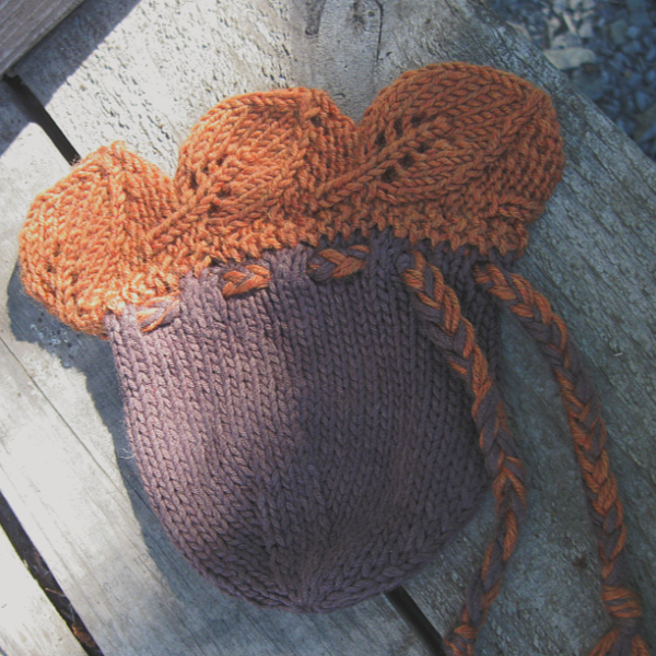 brown knitted pouch with an orange knitted leaf top edge