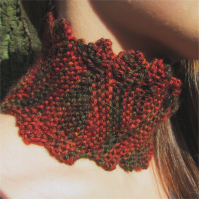 knitted collar with a zig zag edge in shades of orange, brown, and green
