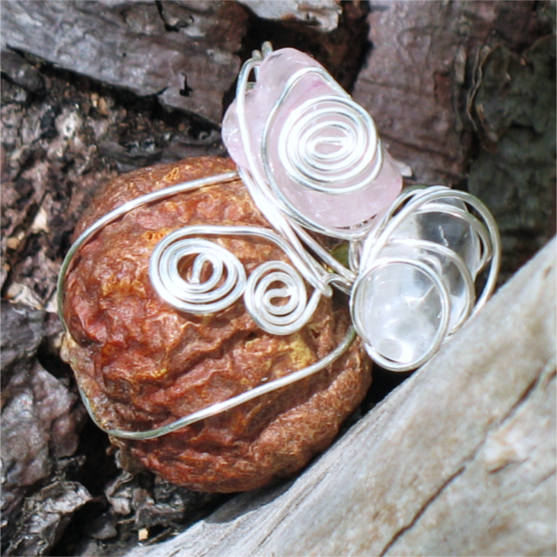 rose hip wrapped in silver wire, adorned with wire spirals, a rose quartz bead, and a clear quartz bead