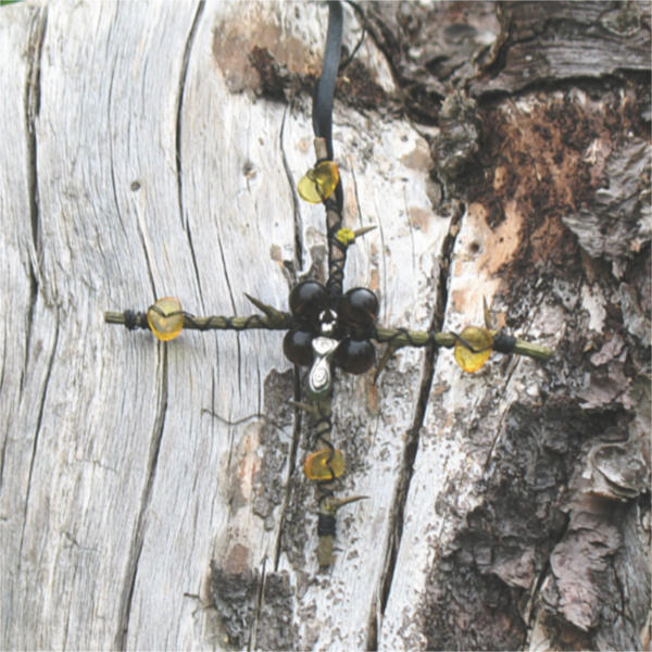 equal armed cross of hawthorn twigs adorned with obsidian, amber, and a tiny goddess charm