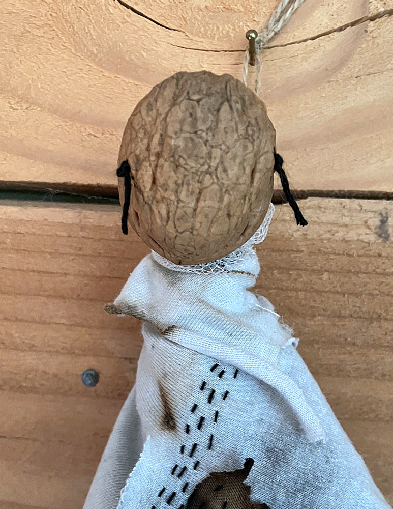 Closeup of the walnut shell face of The Cailleach doll.