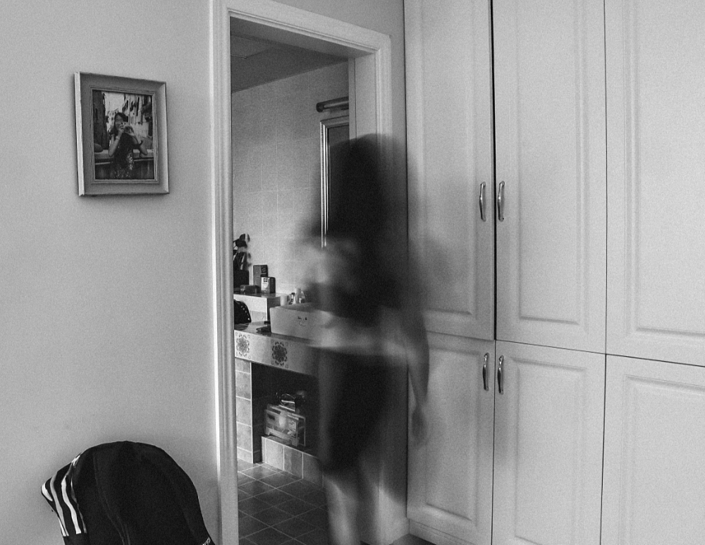 a ghostly form moving through a house