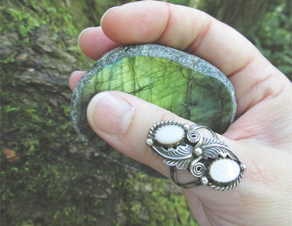 a hand holding a piece of labradorite