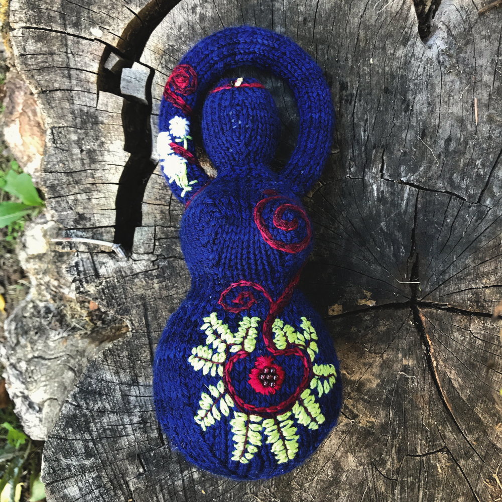 knitted goddess embellished with ferns and a pomegranate