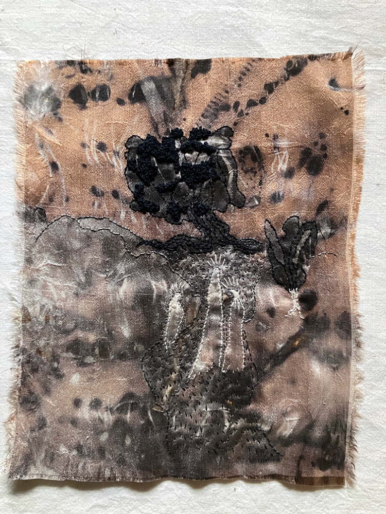 A surreal stitched art piece featuring three indistinct figures walking a winding, wide path toward a tree on a hill, in shdes of black, white, brown, and gray